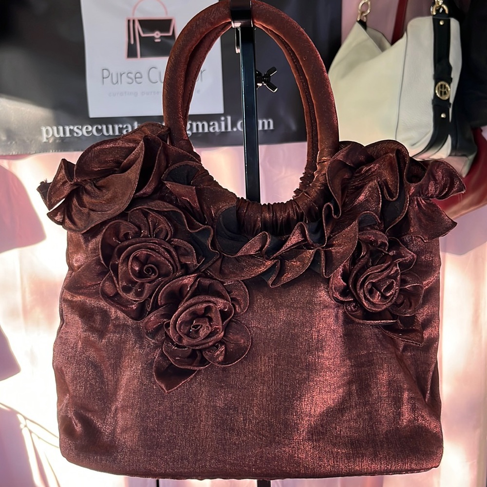 Pretty fabric satchel in a bronze metallic finish and rolled handles.